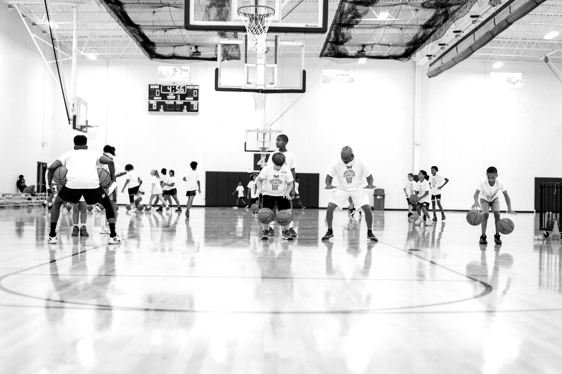 Young people practicing basketball together at a Holy Hooper camp